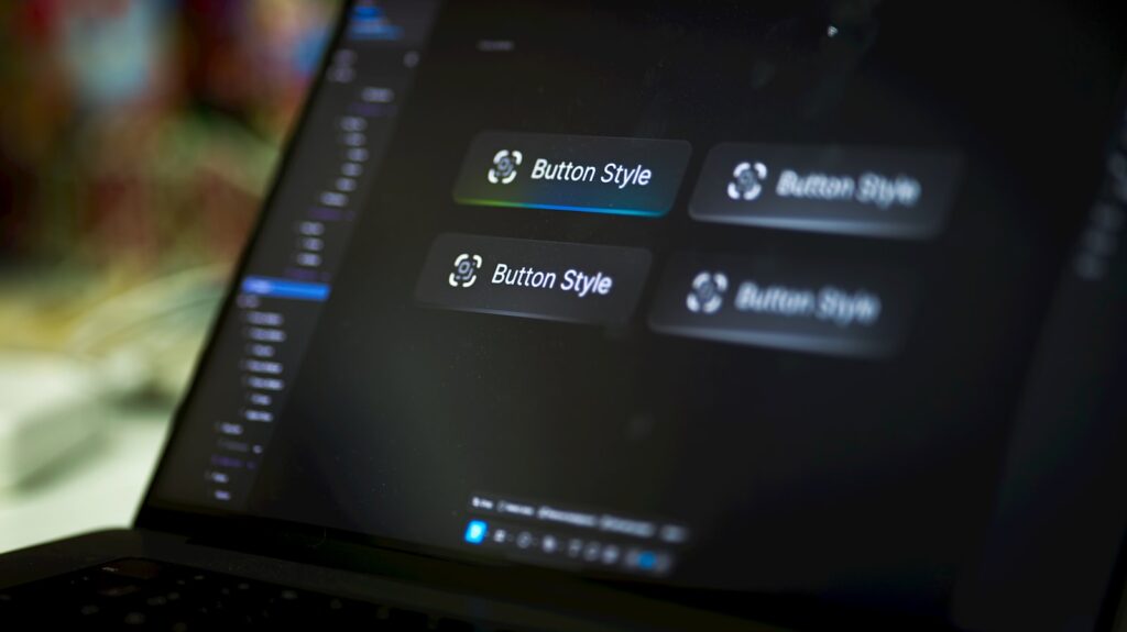 Design workspace with UI button style options on a laptop screen