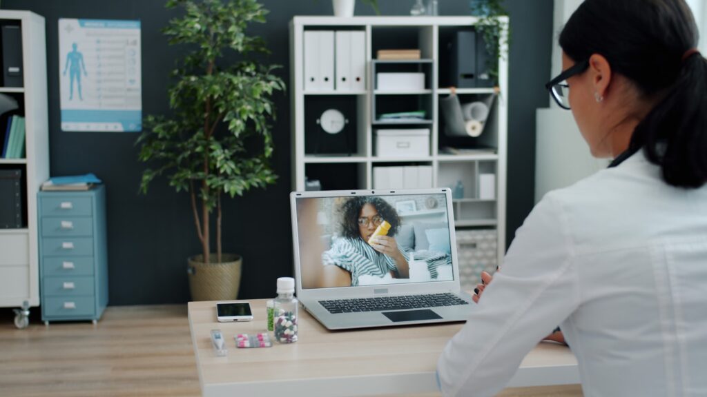 Doctor consulting a patient via video call on a laptop