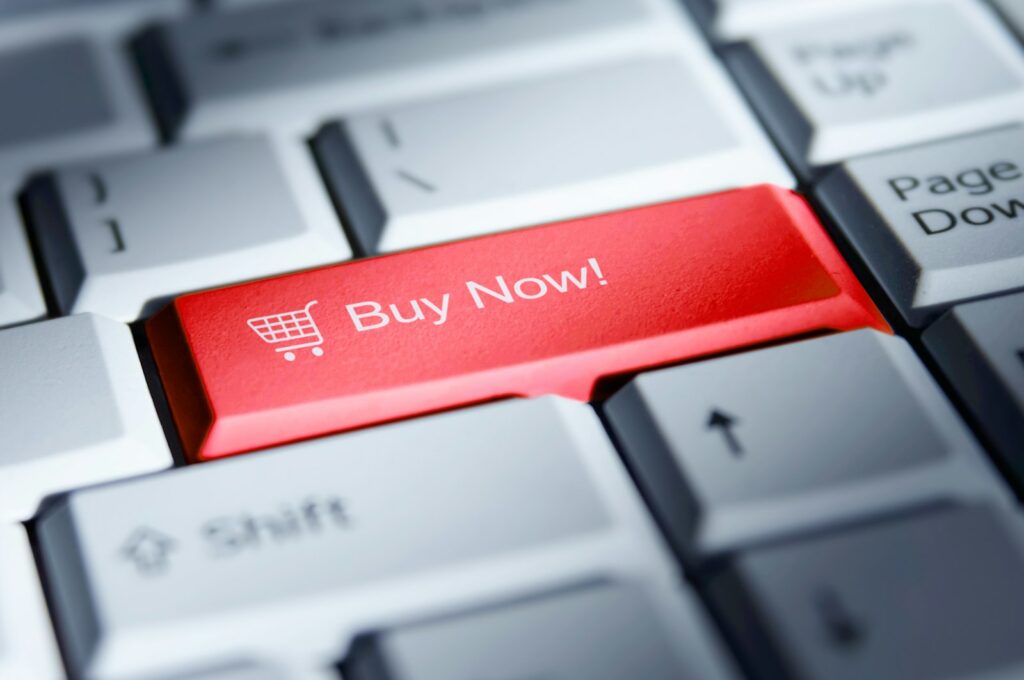 A red buy now button on a computer keyboard