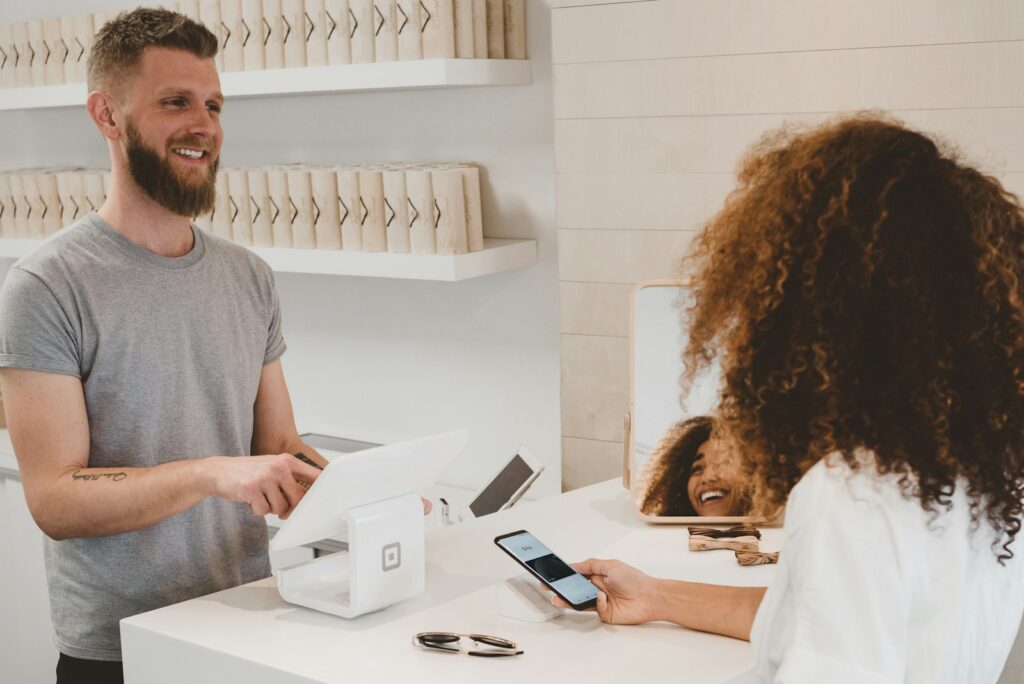 A hand holding a bank card at a payment terminal