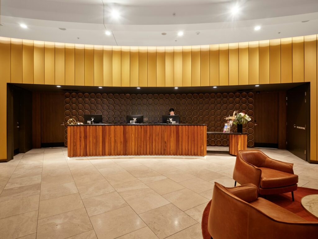A modern hotel reception desk with wooden furniture