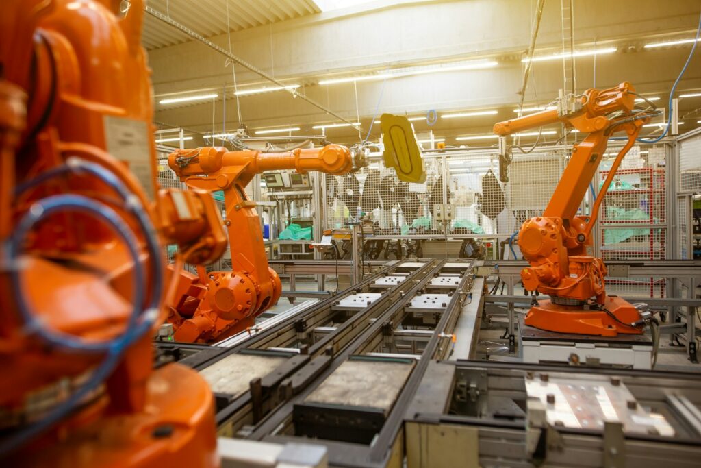 A factory floor filled with orange industrial robot machines