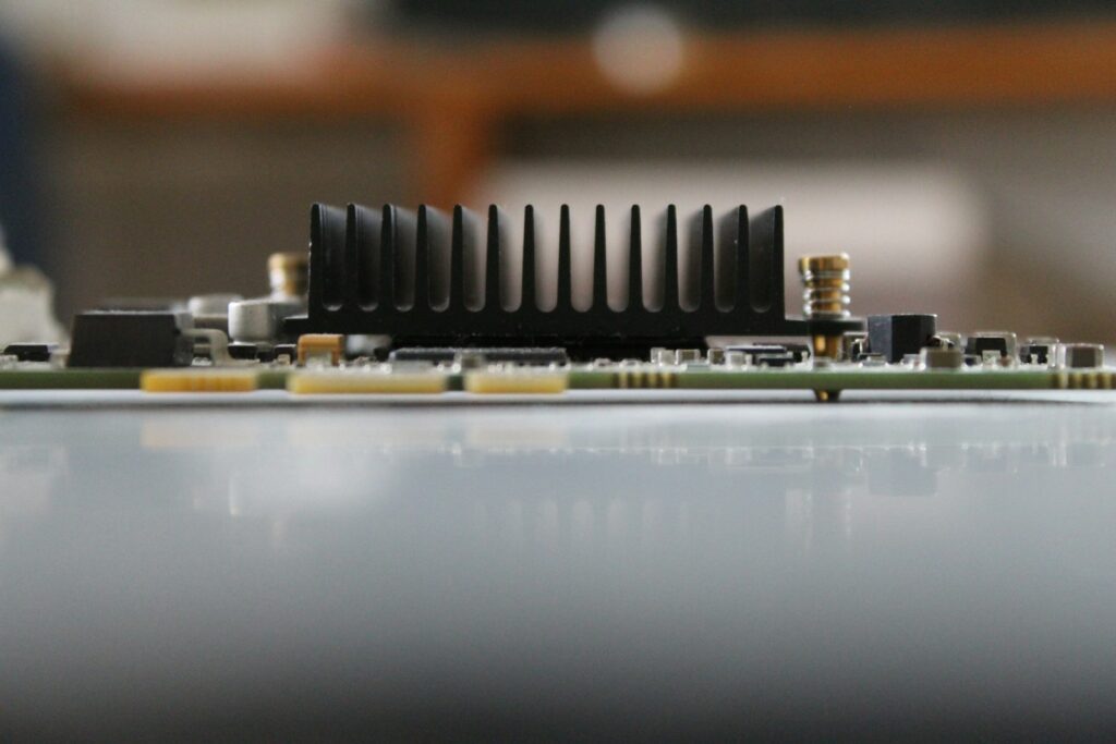 A close-up of a computer motherboard with many screws and components