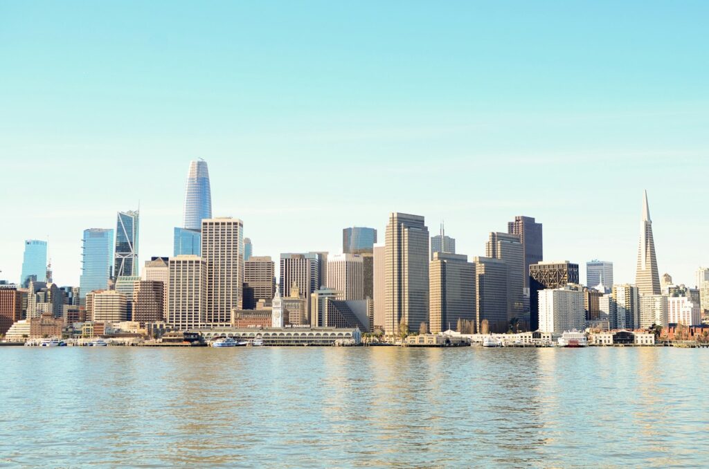 The San Francisco city skyline seen across a body of water during daytime