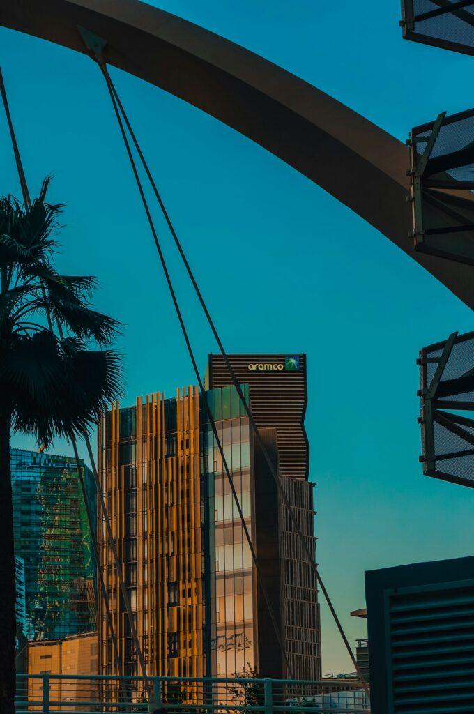 Modern building, bridge and palm tree against a blue sky in Saudi Arabia