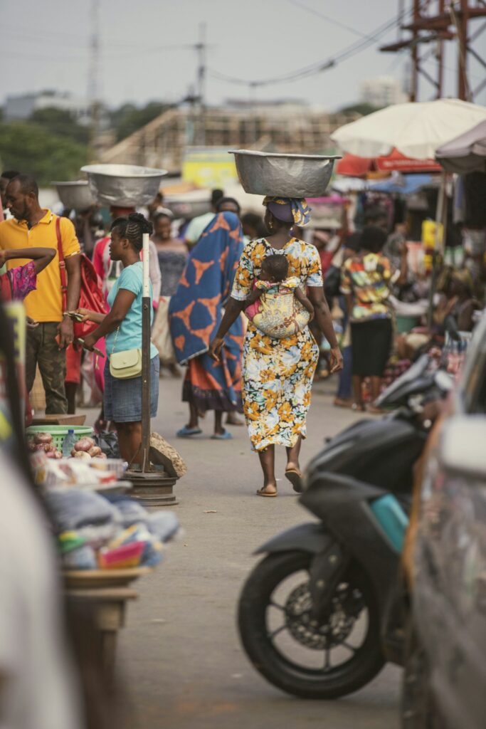 A woman walking down a street carrying a bag