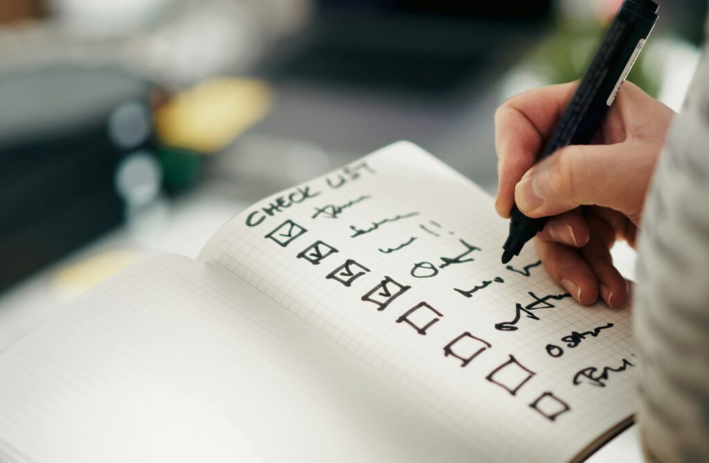 Someone checking items off a printed checklist