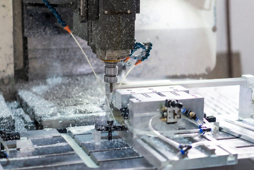A machine cutting a piece of metal on a factory floor