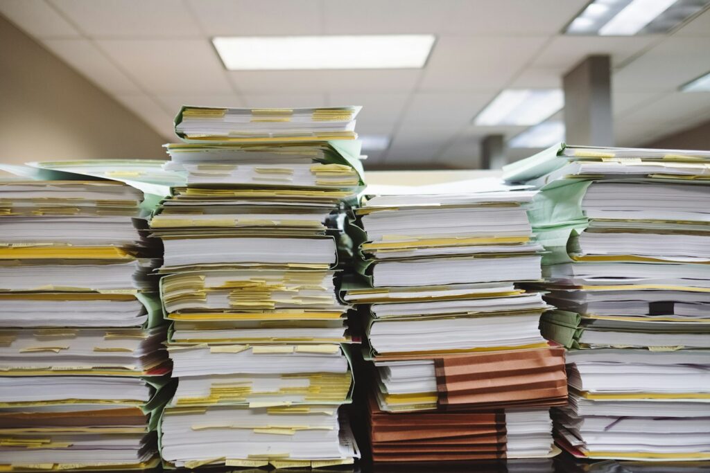 Stacks of paper documents and file folders in an office