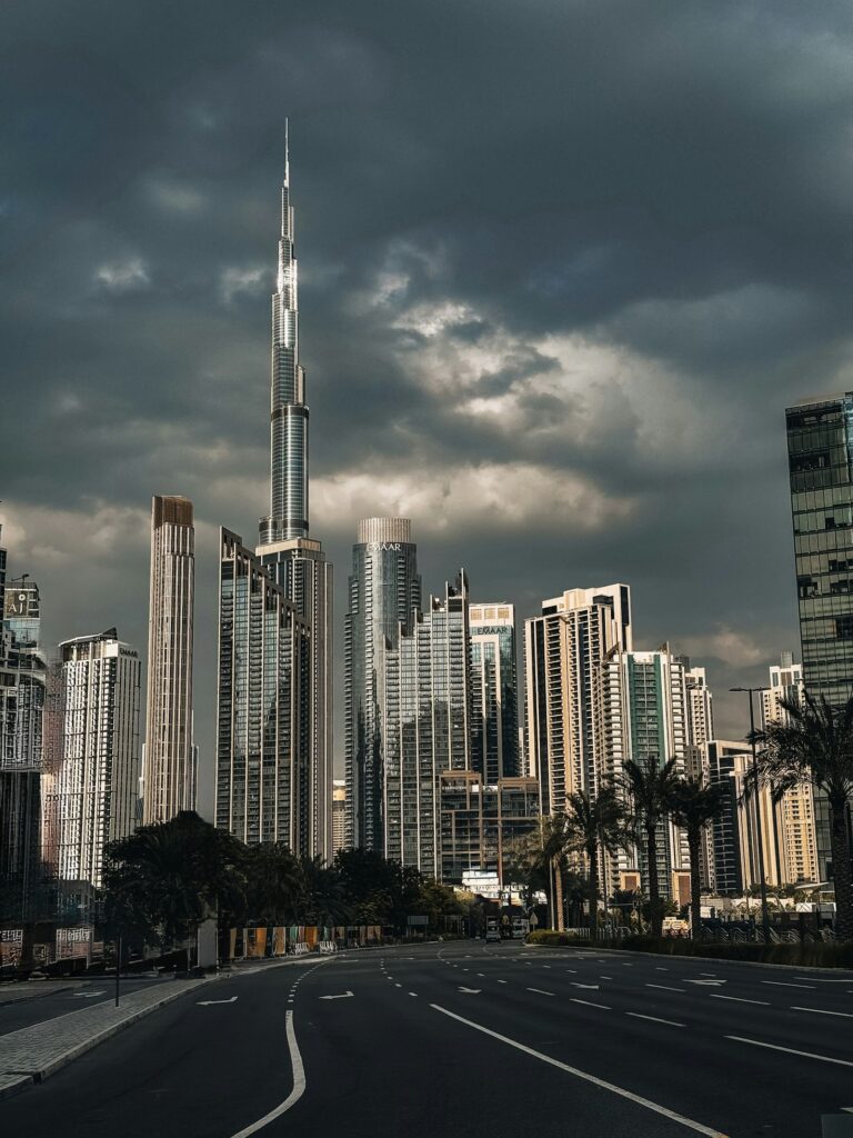 A city street in Dubai with many tall office buildings