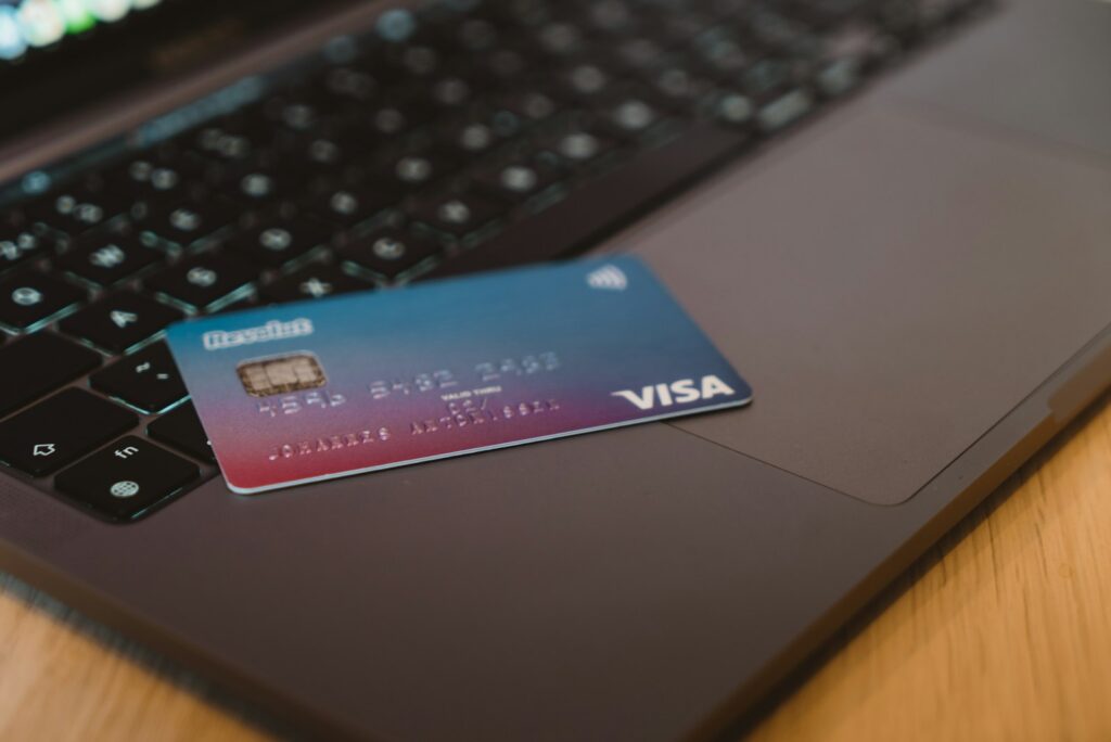 A blue and red gradient payment card resting on a surface