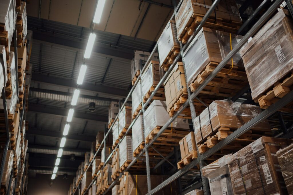 Brown cardboard boxes stacked on a white metal rack