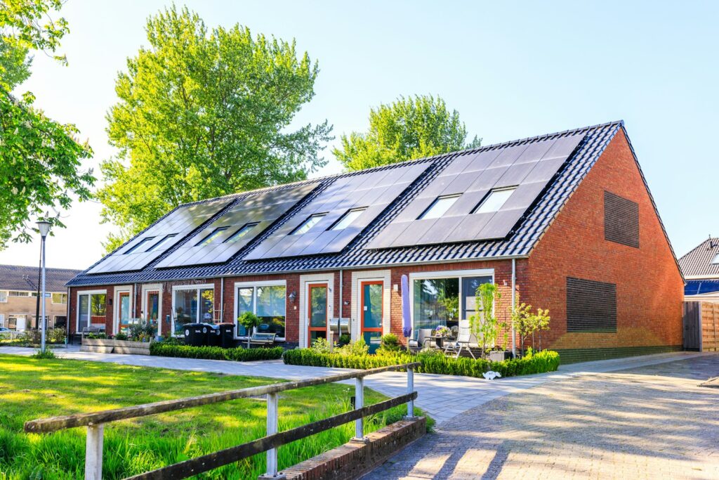 A house with a large array of solar panels on its roof