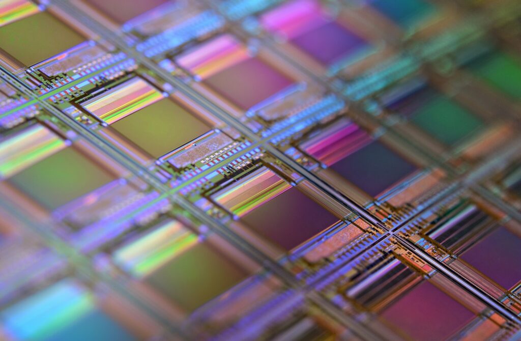 A silicon wafer showing a grid of iridescent microchips